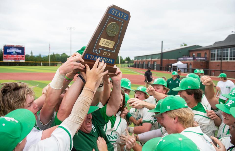 Holtville players celebrate with the championship trophy after defeating Sardis during the AHSAA baseball class 5A state championship at Rudy Abbot Field in Jacksonville, Ala., on Friday, May 19, 2023. Holtville defeated Sardis 3-1 to sweep the series 2-0.