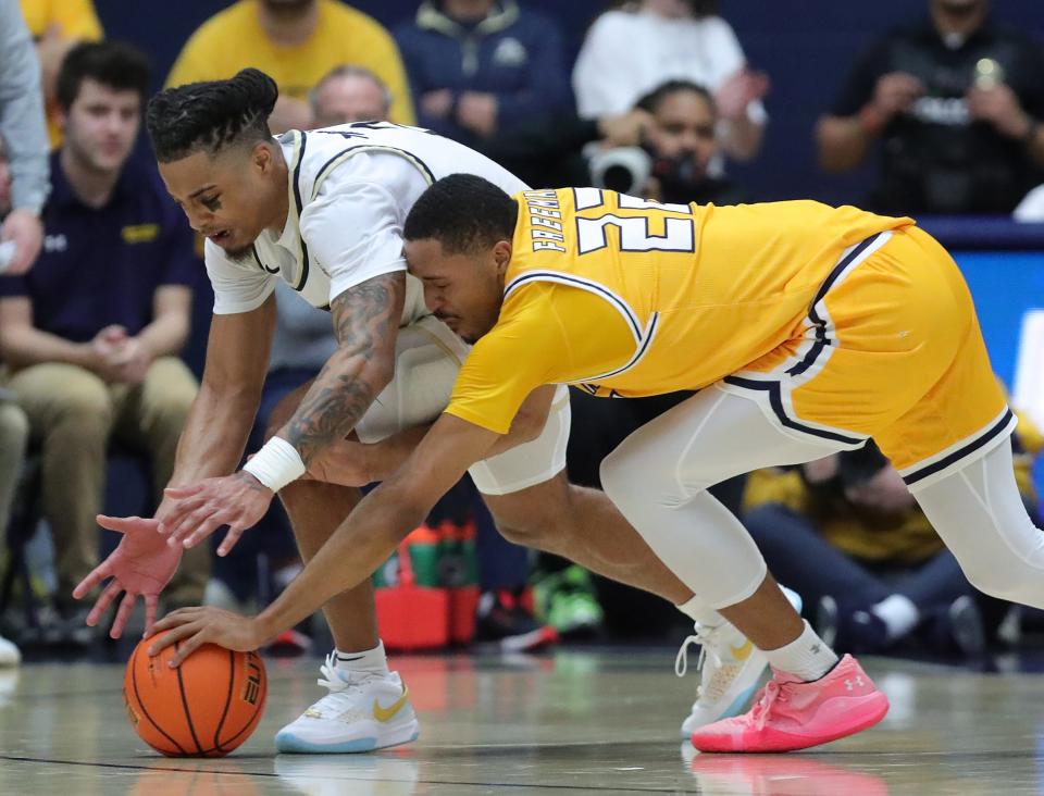 Akron Zips guard Greg Tribble, left, goes after a loose ball with Kent State guard Tyem Freeman during the second half, Friday, Feb. 23, 2024.