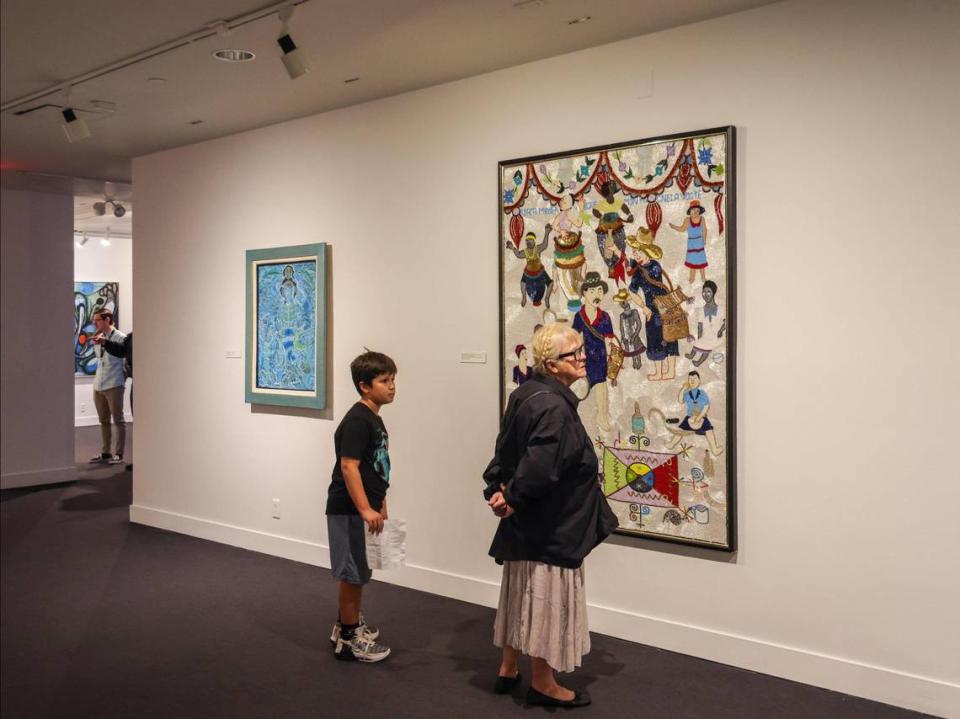 Art lovers browse through Haitian art show entitled “Cosmic Mirrors” at NSU Art Museum in Fort Lauderdale, Florida.