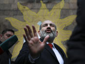 Acting Armenian Prime Minister Nikol Pashinian gestures as he leaves a polling station during an early parliamentary election in Yerevan, Armenia, Sunday, Dec. 9, 2018. The charismatic 43-year-old Nikol Pashinian took office in May after spearheading massive protests against his predecessor's power grab that forced the politician to step down. (Vahan Stepanyan/PAN Photo via AP)