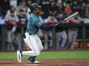 Seattle Mariners' Julio Rodriguez watches his RBI single against the Boston Red Sox during the 10th inning of a baseball game Saturday, March 30, 2024, in Seattle. The Mariners won 4-3 in 10 innings. (AP Photo/Stephen Brashear)