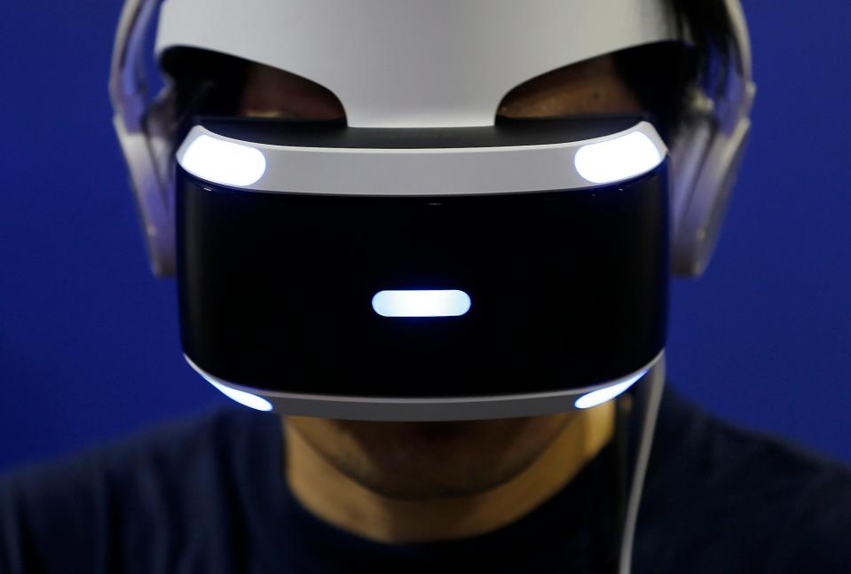 A visitor wearing a PlayStation VR headset plays a video game in the Sony Interactive Entertainment Inc. booth at Tokyo Game Show (Yuya Shino/Getty Images for TOKYO GAME SHOW)