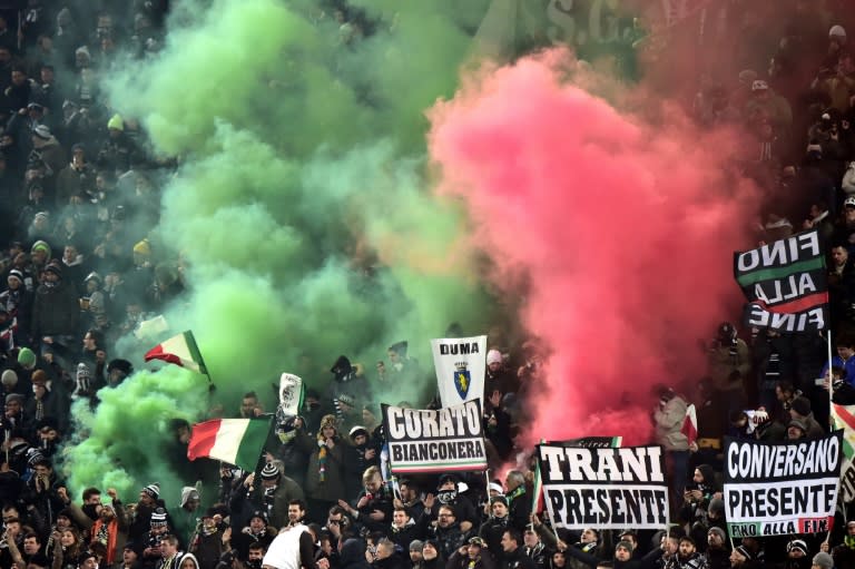 Juventus' supporters light smoke bombs during the Italian Serie A football match Juventus vs AS Roma at "Juventus Stadium" in Turin on January 24, 2016