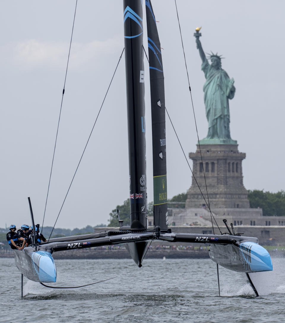 In this photo provided by SailGP, New Zealand SailGP Team, helmed by Peter Burling, pass the Statue of Liberty on Race Day 2 of the Mubadala New York Sail Grand Prix in New York, Sunday, June 23, 2024. (Bob Martin/SailGP via AP)