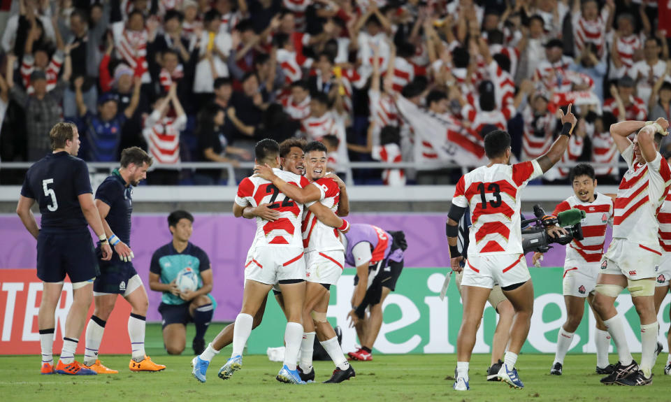 Japan players celebrate after defeating Scotland 28-21 in their Rugby World Cup Pool A game at International Stadium in Yokohama, Japan, Sunday, Oct. 13, 2019. (AP Photo/Christophe Ena)