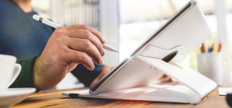 Man using a stylus on a large tablet.