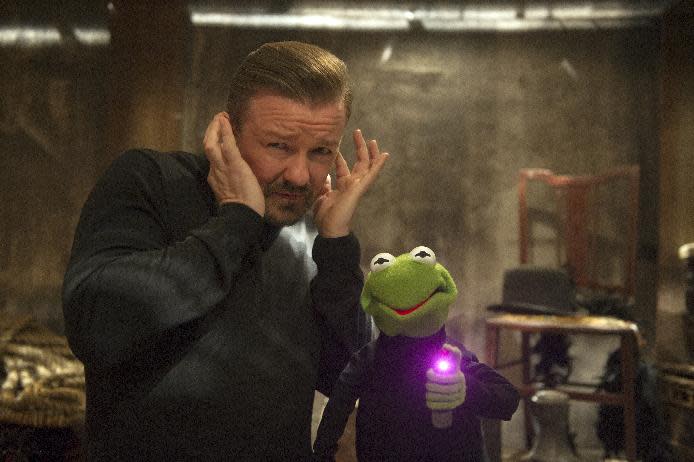 This image released by Disney shows Ricky Gervais, left, with muppet character Constantine, a Kermit the frog look-alike, in a scene from "Muppets Most Wanted." (AP Photo/Disney Enterprises, Inc., Jay Maidment)