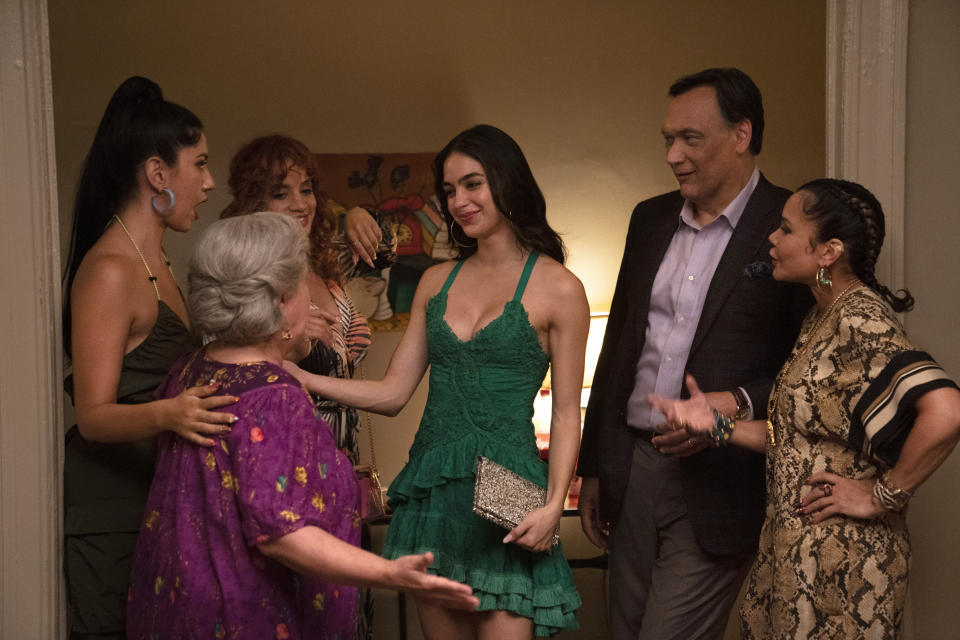 This image released by Warner Bros. Pictures shows, from left, Stephanie Beatriz, from left, Olga Merediz, Dascha Polanco, background obscured, Melissa Barrera, Jimmy Smits and Daphne Rubin-Vega in a scene from "In the Heights." (Macall Polay/Warner Bros. Pictures via AP)