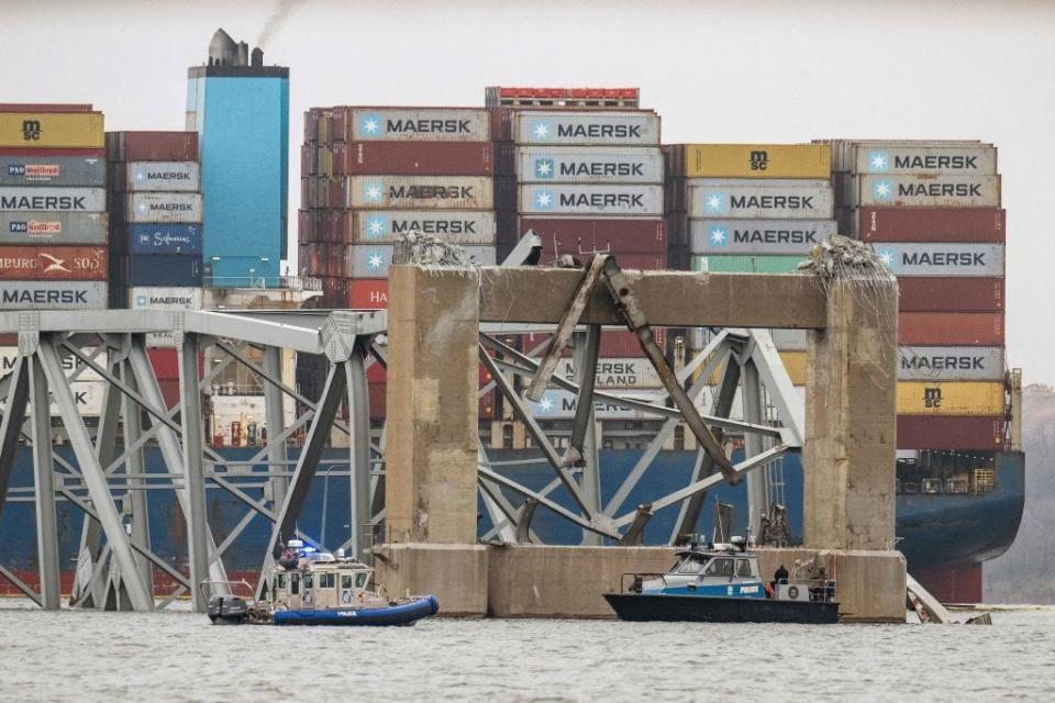 The collapsed Francis Scott Key Bridge lies on top of the container ship Dali in Baltimore, Maryland, on March 27, 2024. Authorities in Baltimore were set to focus on expanding recovery efforts on March 27 after the cargo ship slammed into the bridge, causing it to collapse and leaving six people presumed dead. All six were members of a construction crew repairing potholes on the bridge when the structure fell into the Patapsco River at around 1:30 am (0530 GMT) on March 26. (Photo by Jim WATSON / AFP) (Photo by JIM WATSON/AFP via Getty Images)