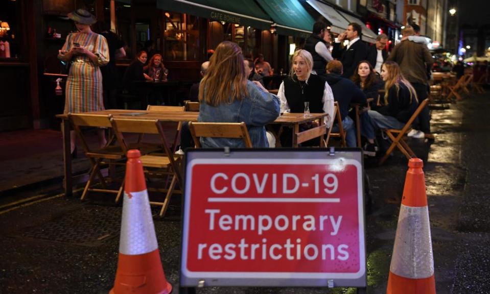 a covid sign outside a bar