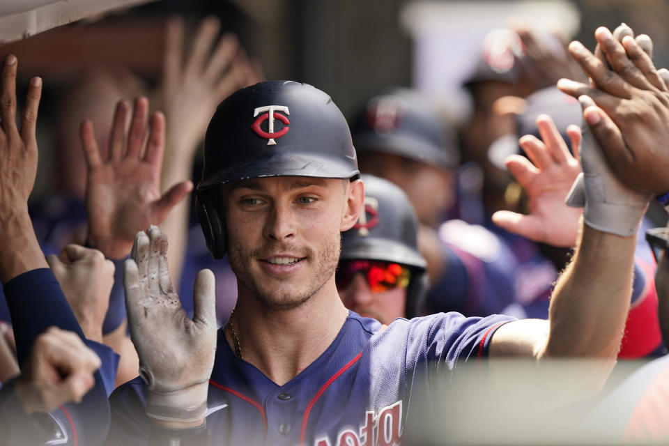 Minnesota Twins' Max Kepler is congratulated by teammates after hitting a three-run home run in the fourth inning of a baseball game against the Cleveland Indians, Sunday, May 23, 2021, in Cleveland. (AP Photo/Tony Dejak)