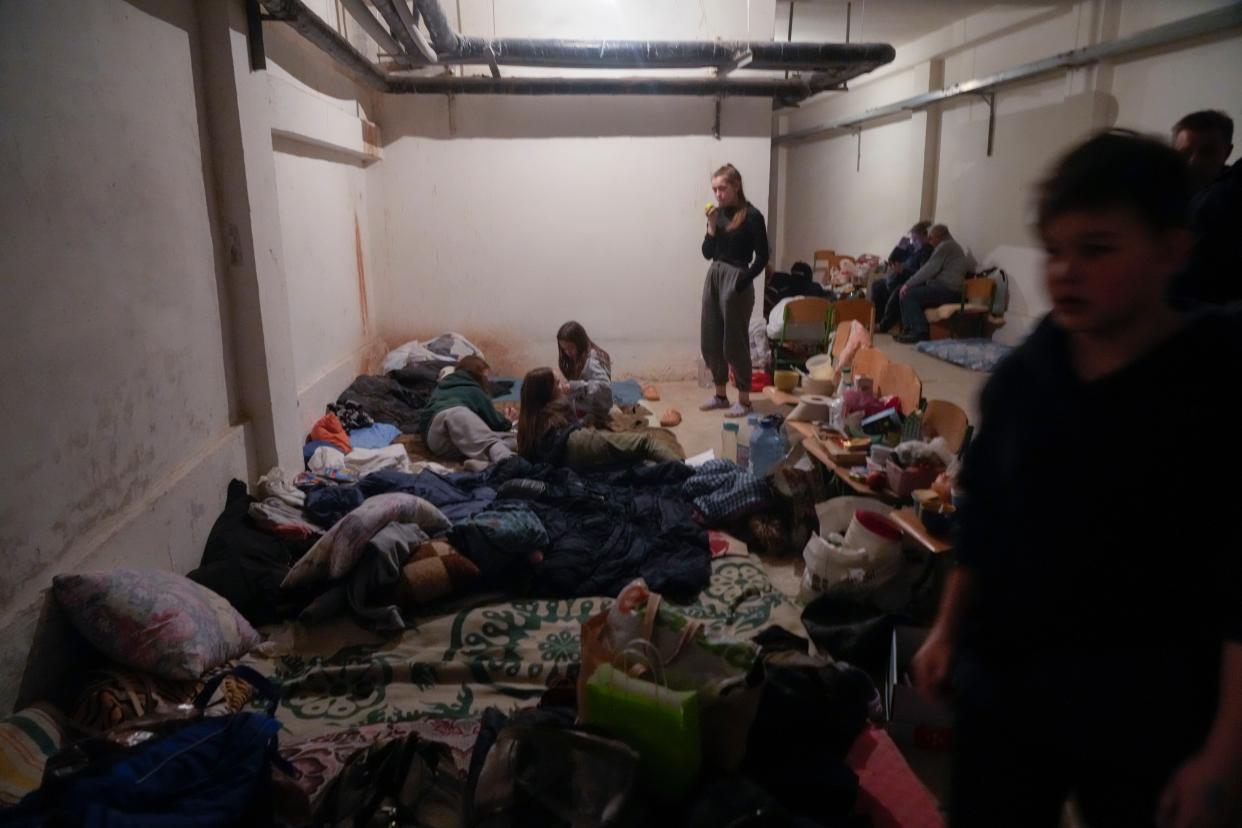 People hide from the Russian artillery shelling in a school basement in the village of Horenka close to Kyiv, Ukraine, on March 6, 2022. On Day 11 of Russia's war on Ukraine, Russian troops shelled encircled cities, and it appeared that a second attempt to evacuate civilians from the besieged port city of Mariupol had failed due to continued violence. 