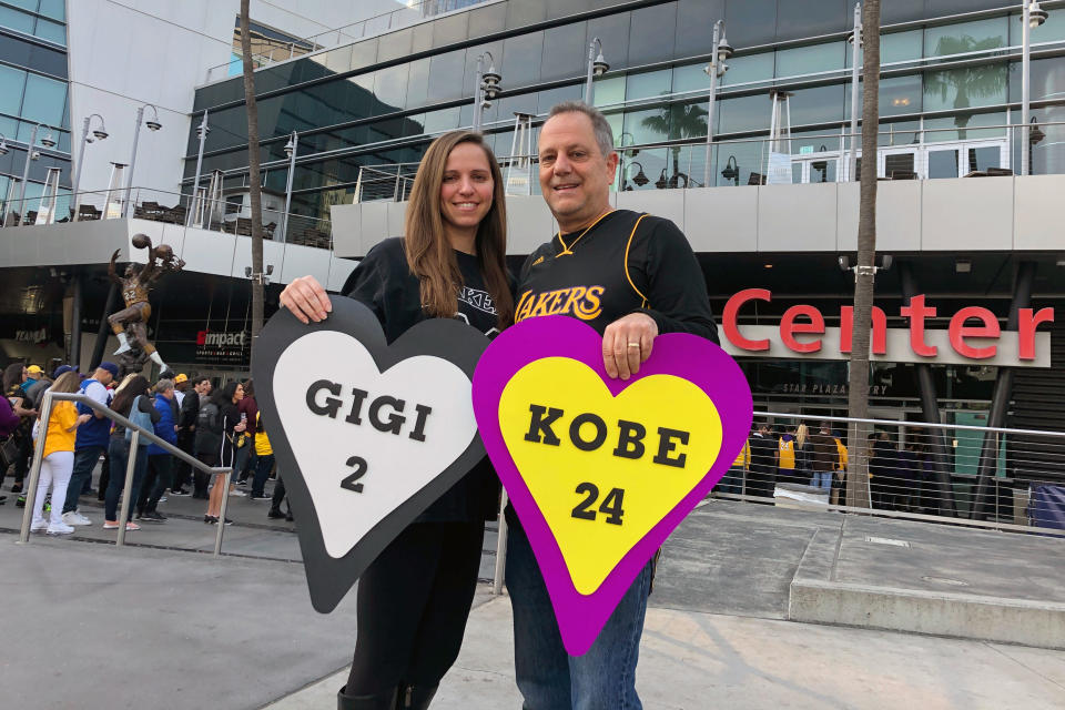 Alyssa Shapiro, 27, of Huntington Beach, and her father Rick Shapiro, 55, stand outside Staples Center in Los Angeles before a public memorial for Lakers legend Kobe Bryant and his daughter, Gianna, Monday morning, Feb. 24, 2020. The family's love of the game — and Bryant's work in women's sports — prompted Alyssa to become a middle school girls' basketball coach. (AP Photo/Stefanie Dazio)