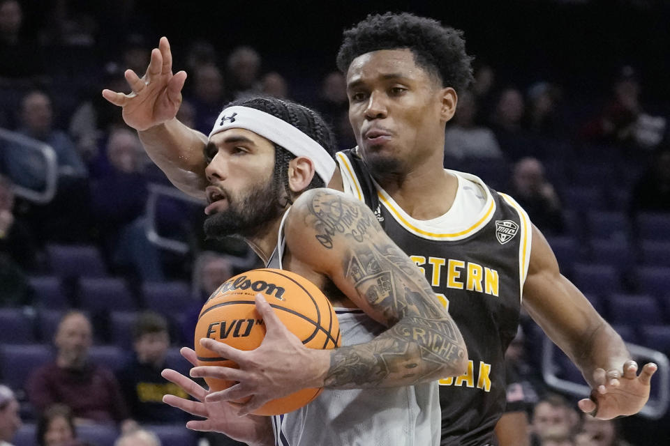 Northwestern guard Boo Buie, left, drives as Western Michigan guard Jefferson De La Cruz Monegro guards during the second half of an NCAA college basketball game in Evanston, Ill., Tuesday, Nov. 14, 2023. (AP Photo/Nam Y. Huh)