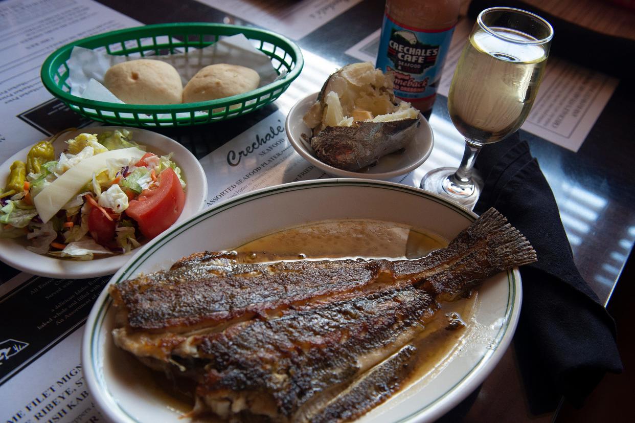 Flounder, which can be ordered at Creshale's grilled or fried, is deboned and served with a salad, baked potato and rolls, at the Jackson, Miss., restaurant Friday, April 22, 2022. Crechale's, a family-owned and operated Jackson restaurant since 1956, is still serving up some of the best steaks and seafood in the city.