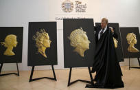 The Royal Mint Chief Executive Adam Lawrence unveils the new portrait of Britain's Queen Elizabeth at the National Portrait Gallery in London March 2, 2015. This is the fifth portrait of the Queen to be used during her reign on British coins. REUTERS/Suzanne Plunkett