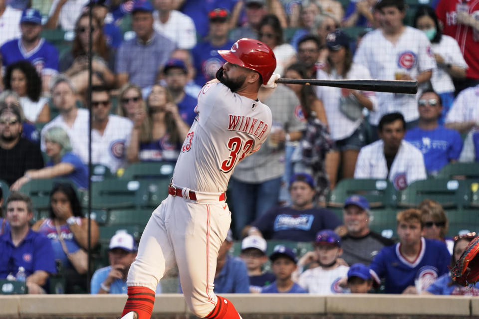 Cincinnati Reds' Jesse Winker watches his home run against the Chicago Cubs during the first inning of a baseball game Tuesday, July 27, 2021, in Chicago. (AP Photo/David Banks)