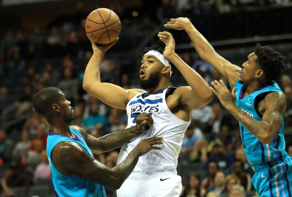 CHARLOTTE, NORTH CAROLINA - OCTOBER 25: Teammates Marvin Williams #2 and Malik Monk #1 of the Charlotte Hornets try to stop Karl-Anthony Towns #32 of the Minnesota Timberwolves during their game at Spectrum Center on October 25, 2019 in Charlotte, North Carolina. NOTE TO USER: User expressly acknowledges and agrees that, by downloading and or using this photograph, User is consenting to the terms and conditions of the Getty Images License Agreement. (Photo by Streeter Lecka/Getty Images)