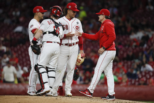 Cincinnati Reds starting pitcher Luis Castillo (58) is relieved by Cincinnati Reds manager David Bell, right, in the seventh inning of a baseball game, Thursday, April 25, 2019, in Cincinnati. (AP Photo/John Minchillo)