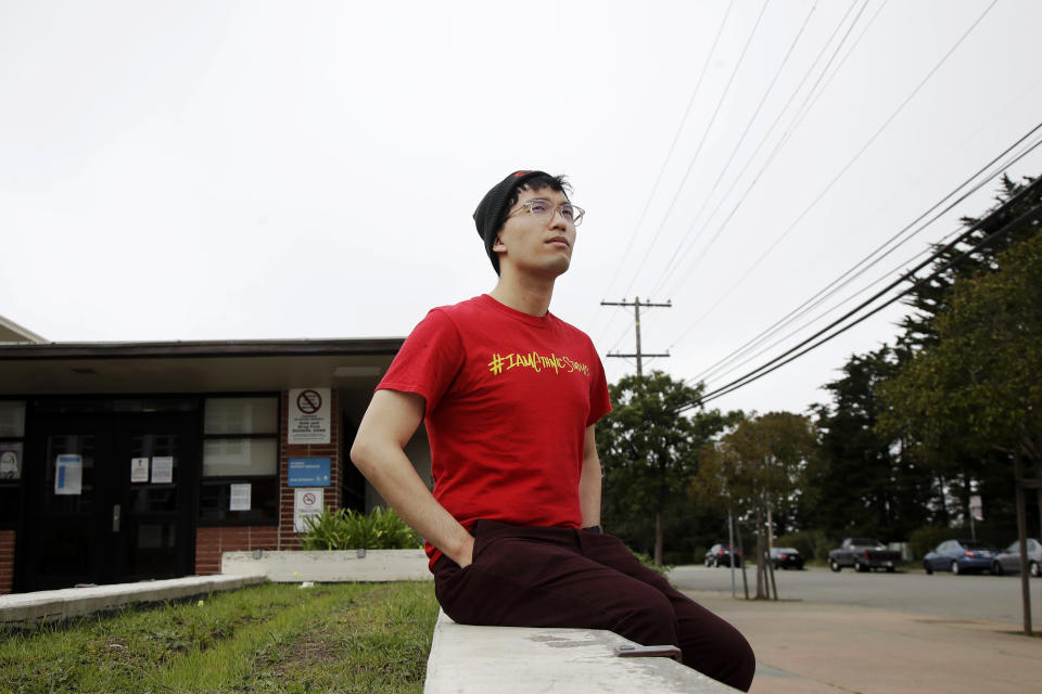 In this March 31, 2020, photo, Kyle Navarro poses in San Francisco. The school nurse was recently unlocking his bicycle when an older white man called him a racial slur and spat at him. Asian Americans are using social media to organize and fight back against racially motivated attacks during the coronavirus pandemic, which the FBI predicts will increase as infections grow. (AP Photo/Jeff Chiu)