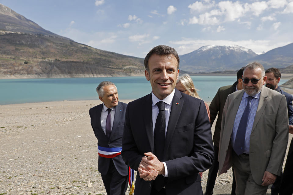 French President Emmanuel Macron speaks to journalists upon his arrival in Sainte-Savine-Le-Lac, southeastern France, Thursday, March 30, 2023. Emmanuel Macron presented a plan for saving France's water after exceptional winter drought, February wildfires and violence between protesters and police over an agricultural reservoir. (Sebastien Nogier, Pool via AP)