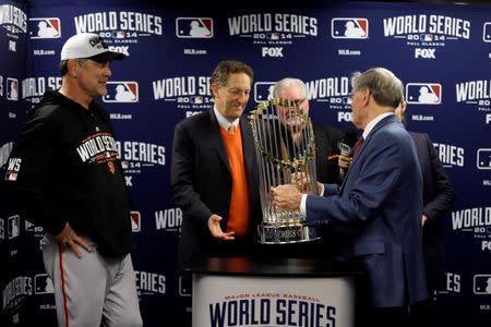 MLB commissioner Bud Selig (right) presents San Francisco Giants manager Bruce Bochy (left) , chief executive officer Larry Baer (middle) and general manager Brian Sabean with the Commissioners Trophy after game seven of the 2014 World Series against the Kansas City Royals at Kauffman Stadium. Charlie Neibergall/Pool Photo via USA TODAY Sports