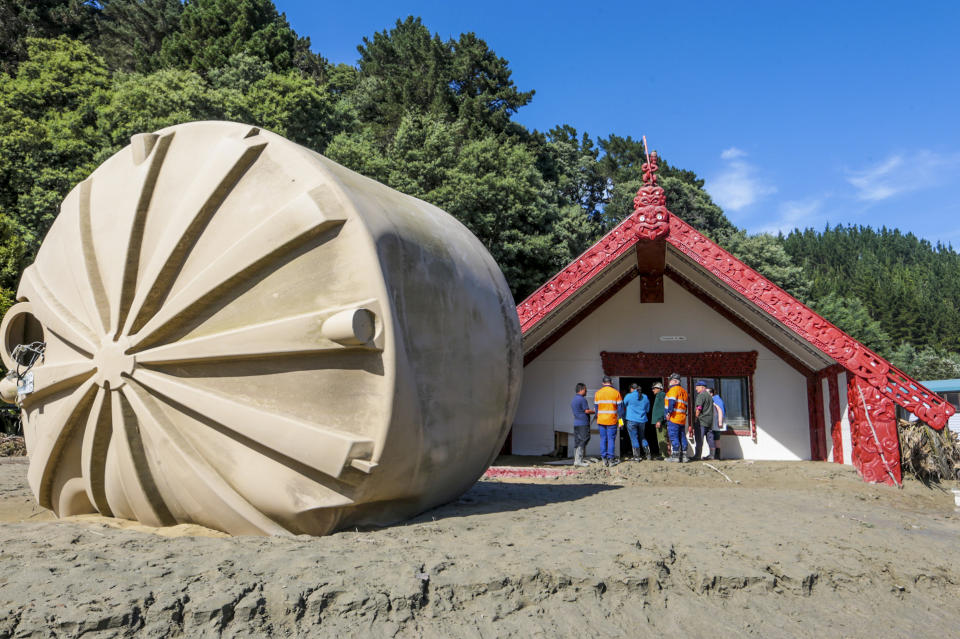 A large water tank lies beside a Maori meeting house at Tangoio Marae following Cyclone Gabrielle in the Hawkes Bay of New Zealand, Sunday, Feb. 19, 2023. Cyclone Gabrielle struck the country's north on Feb. 13 and the level of damage has been compared to Cyclone Bola in 1988. That storm was the most destructive on record to hit the nation of 5 million people. (Paul Taylor/Hawkes Bay Today via AP)