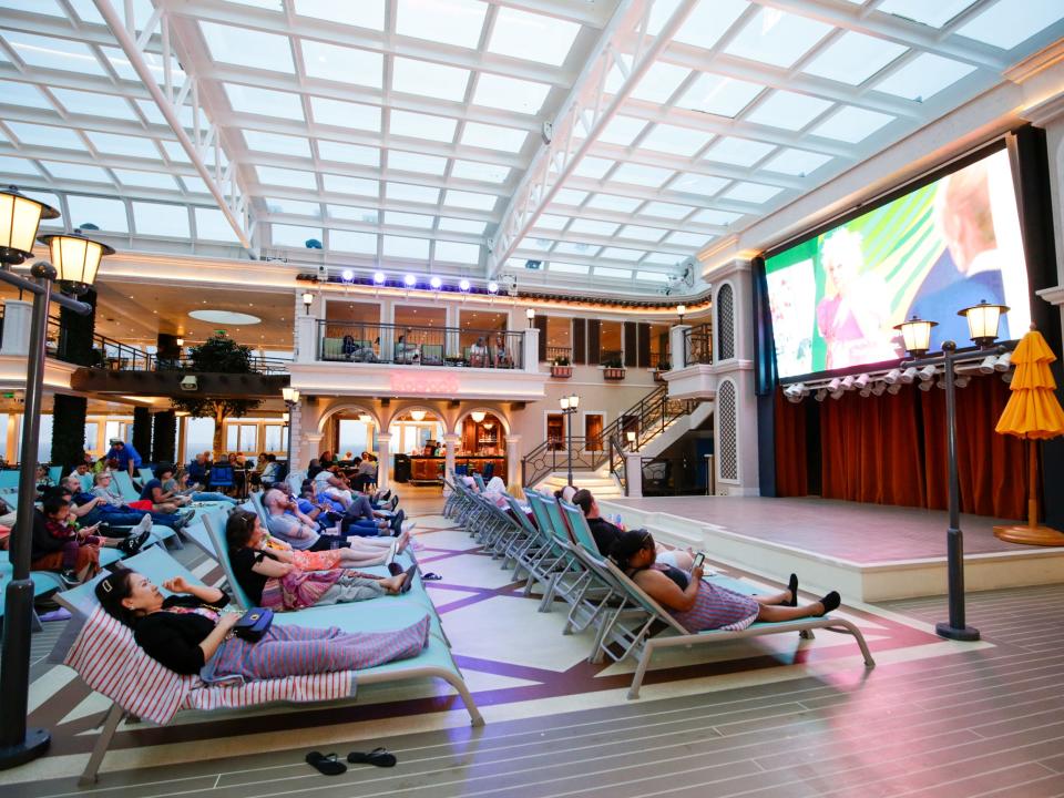 People watching a movie in a cinema inside a cruise ship.