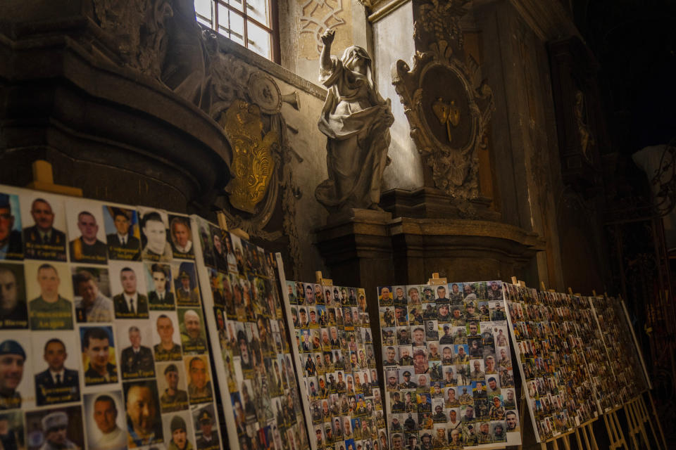 Photographs of Ukrainian soldiers killed during the Russian Ukrainian war are displayed in the Saints Peter and Paul church in Lviv, Ukraine, April 16, 2024. (AP Photo/Francisco Seco)