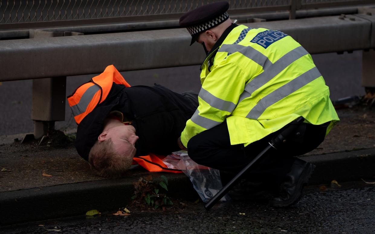 Just Stop Oil protestors are arrested by police as they attempt to block the A41