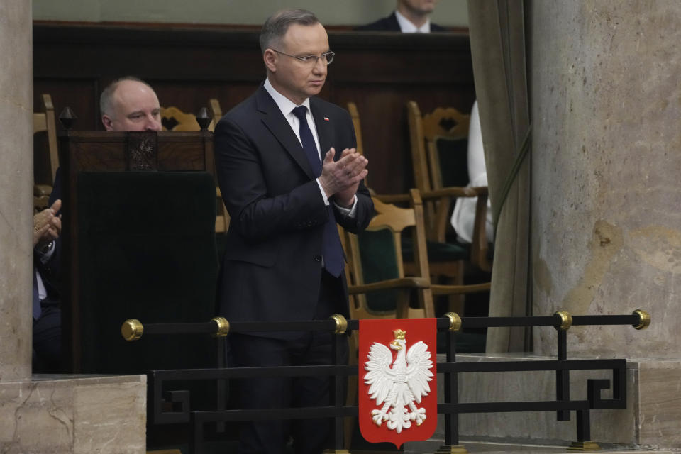 Poland's President Andrzej Duda applauds in the Polish parliament in Warsaw, Poland, Thursday, 25 April 2024, after a policy speech in which Foreign Minister Radek Sikorski said Poland wants to return to the group of countries that sets the agenda for the European Union. (AP Photo/Czarek Sokolowski)