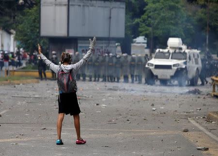 A demonstrator gestures towards riot security forces while rallying against Venezuela's President Nicolas Maduro's government in Caracas, Venezuela, July 22, 2017. REUTERS/Andres Martinez Casares