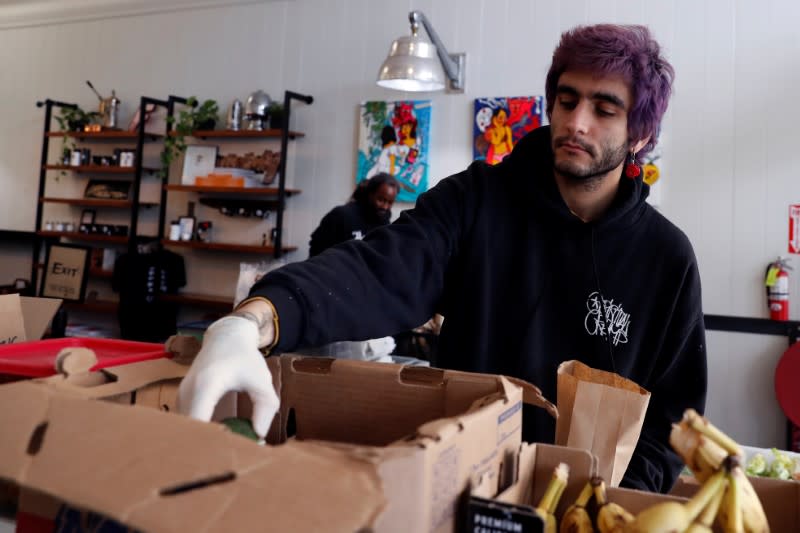 An employee of Farley’s East cafe, that closed due to the financial crisis caused by the coronavirus disease (COVID-19), collects produce that was given to laid off employees at the cafe in Oakland