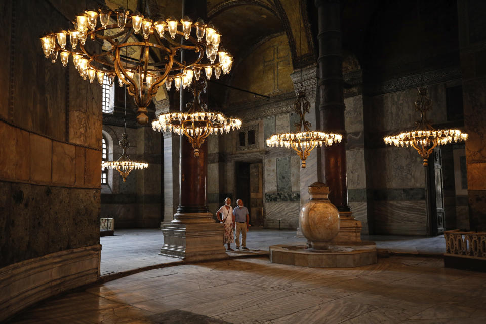 People visit the Byzantine-era Hagia Sophia, one of Istanbul's main tourist attractions in the historic Sultanahmet district of Istanbul, Thursday, June 25, 2020 photo. The 6th-century building is now at the center of a heated debate between conservative groups who want it to be reconverted into a mosque and those who believe the World Heritage site should remain a museum. (AP Photo/Emrah Gurel)