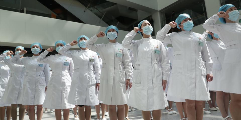 Nurses wearing face masks take part in an event held to mark the International Nurses Day, at Wuhan Tongji Hospital in Wuhan, the Chinese city hit hardest by the coronavirus disease (COVID-19) outbreak, in Hubei province, China May 12, 2020. China Daily via REUTERS ATTENTION EDITORS - THIS IMAGE WAS PROVIDED BY A THIRD PARTY. CHINA OUT.