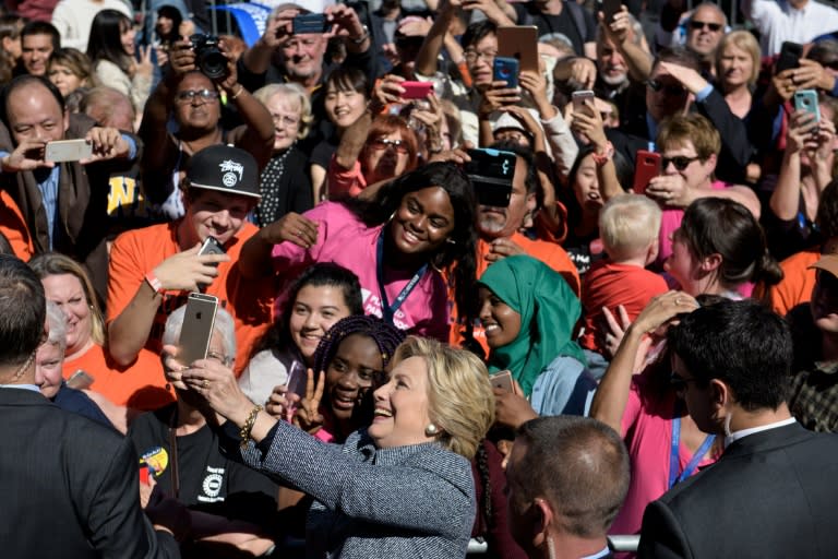 Democratic presidential nominee Hillary Clinton takes a selfie during an Iowa Democratic party early vote rally September 29, 2016 in Des Moines, Iowa