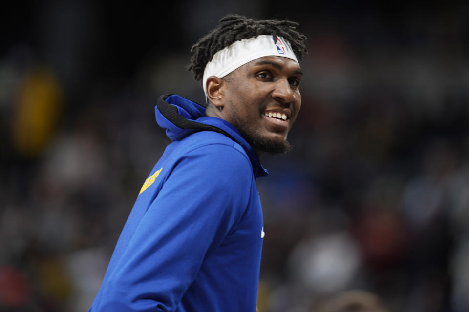 FILE - Golden State Warriors center Kevon Looney (5) smiles during the first half of an NBA basketball game Thursday, March 10, 2022, in Denver. The NBA's free agency period opens Thursday night, June 30, 2022, with teams and players finally free to negotiate new deals. (AP Photo/David Zalubowski, File)