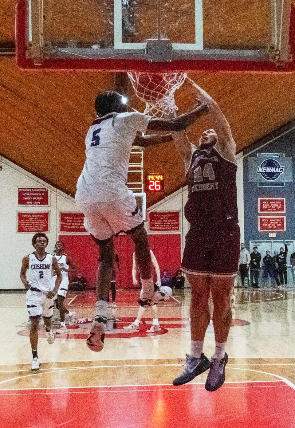 Worcester Academy’s Kayvaun Mulready dunks on Cushing Academy’s Adrian Uchidiuno during a game last season.