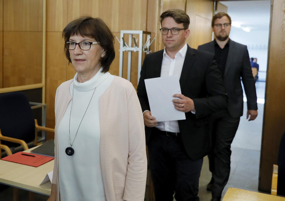 Walter Luebcke's widow Irmgard Braun-Luebcke, left and her sons Jan-Hendrick Luebcke and Christoph Luebcke in the courtroom for the continuation of the trial in Frankfurt, Germany, Thursday, July 2, 2020. A far-right extremist in Germany was convicted Thursday, Jan. 28, 2021 and sentenced to life in prison for the murder of a regional politician who had advocated helping refugees — a brazen killing that shocked the country. Prosecutors, defendants and co-plaintiffs have lodged appeals against the verdict. (Ronald Wittek/Pool Photo via AP)