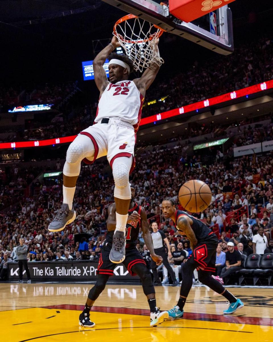 Miami Heat forward Jimmy Butler (22) dunks the ball as Chicago Bulls players look on during the fourth quarter of an NBA play-in tournament game at Kaseya Center in Downtown Miami, Florida, on Friday, April 14, 2023.