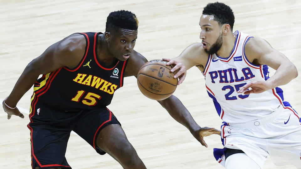 Ben Simmons drives past Atlanta Hawks player Clint Capela.