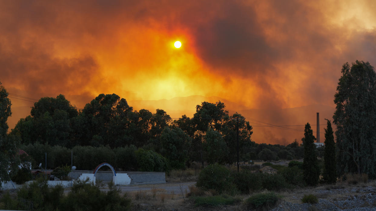 RHODES ISLAND, GREECE - JULY 25: Smoke rises as teams try to extinguish wildfires on Rhodes island, Greece on July 25, 2023. Some 19,000 people have been evacuated from the Greek island of Rhodes as wildfires continued burning for a sixth day, authorities said on Sunday. As many as 266 firefighters and 49 fire engines were on the ground battling the blazes, assisted by five helicopters and 10 airplanes. (Photo by Ahmed Abbasi/Anadolu Agency via Getty Images)