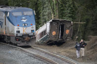 <p>Law enforcement work at the scene of a Amtrak train derailment on December 18, 2017, 2017 in DuPont, Washington. The derailment also closed southbound I-5. (Photo: Stephen Brashear/Getty Images) </p>
