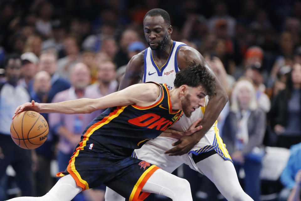 Oklahoma City Thunder forward Chet Holmgren, front, drives as Golden State Warriors forward Draymond Green defends during the second half of an NBA in-season tournament basketball game Friday, Nov. 3, 2023, in Oklahoma City. (AP Photo/Nate Billings)