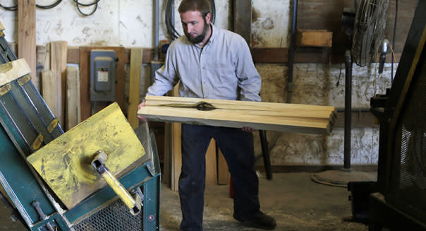 <b class="credit">Getty Images</b>A worker loads boards into an automated saw as wood pallets are manufactured at the Plainview Pallet Co. facility in Auburn, Ky.