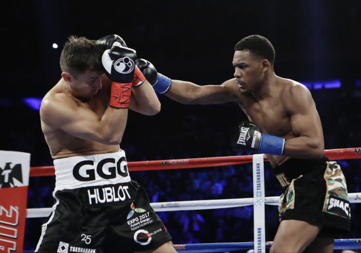 Daniel Jacobs (R) lands a punch on Gennady Golovkin during their title fight on Saturday. (Getty) 