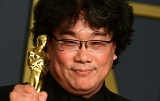 "Parasite" director Bong Joon-ho poses with one of the four Oscars his film won on a historic night for foreign language cinema