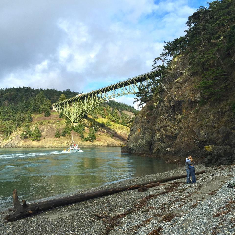 A couple embraces on North Beach with Deception Pass Bridge as a backdrop in Deception Pass State Park, Whidbey Island, Wash., on Feb. 14, 2015. Deception Pass, located about 80 miles from Seattle, is the name of the strait that divides Washington’s Whidbey Island from Fidalgo Island.