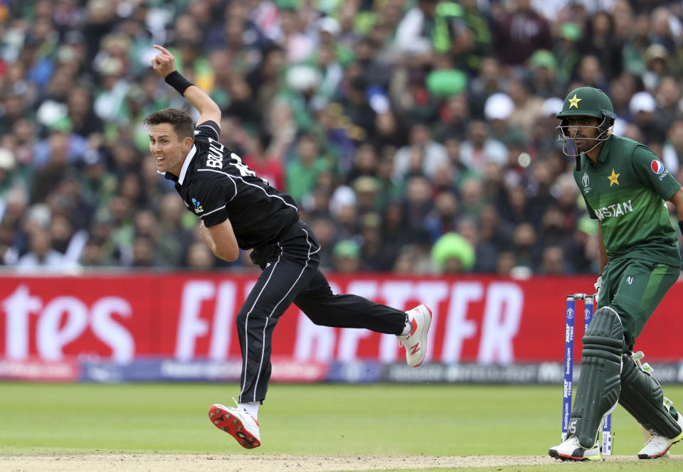 New Zealand's bowler Trent Boult, left, follows through his delivery Pakistan's batsman Babar Azam watches on during the Cricket World Cup match between New Zealand and Pakistan at the Edgbaston Stadium in Birmingham, England, Wednesday, June 26, 2019. (AP Photo/Rui Vieira)