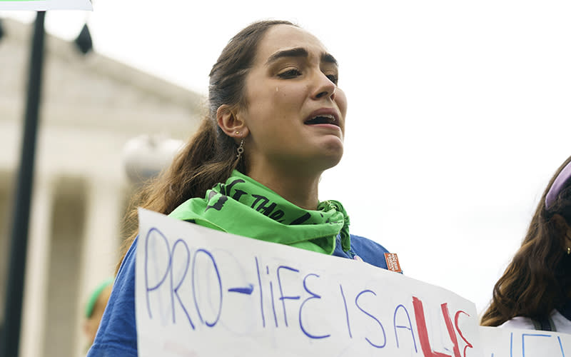 A protester in favor of abortion rights is seen with a "Pro-life is a lie" sign
